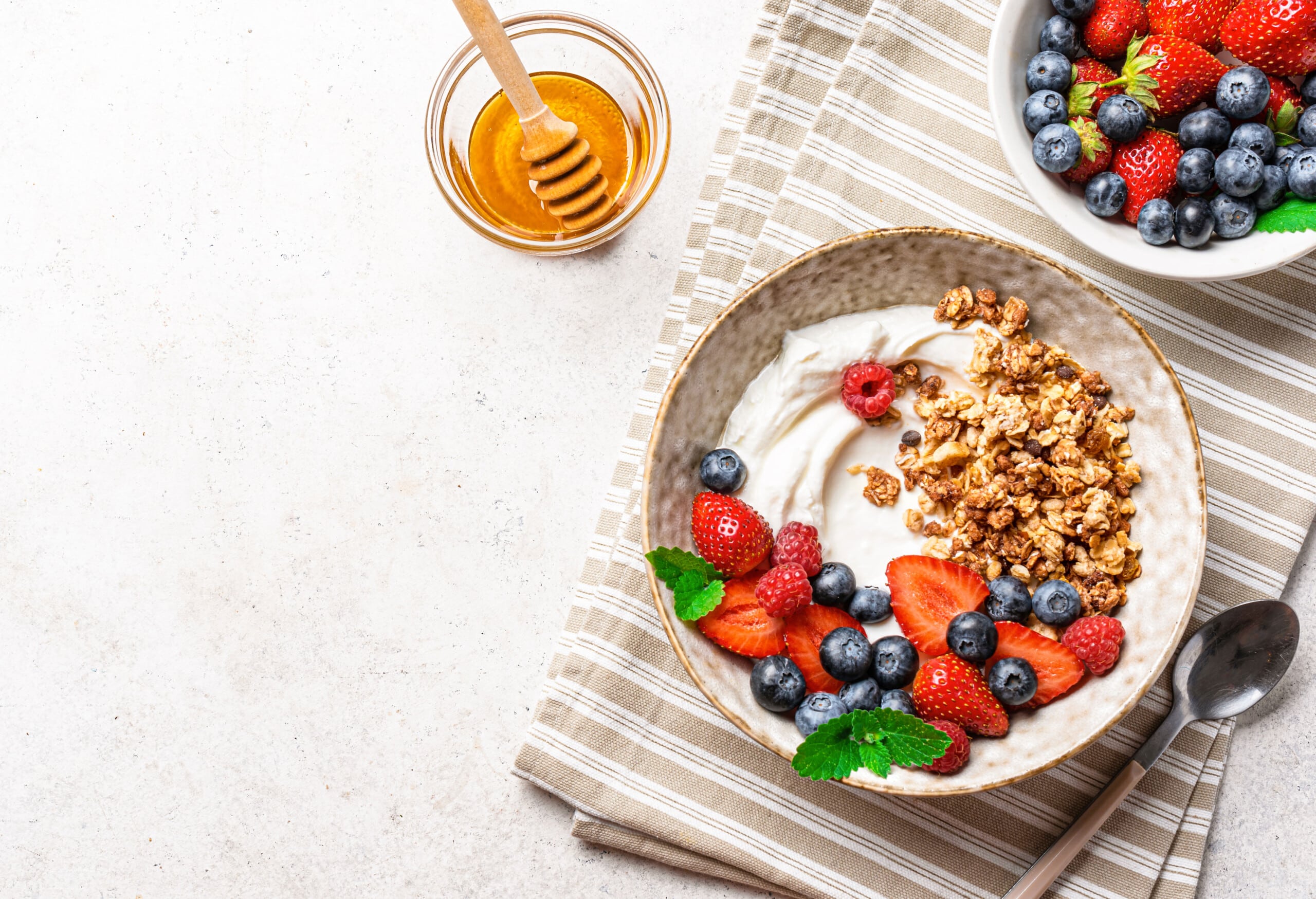Joghurt mit Beeren, zuckerfreiem Müsli und Honig.